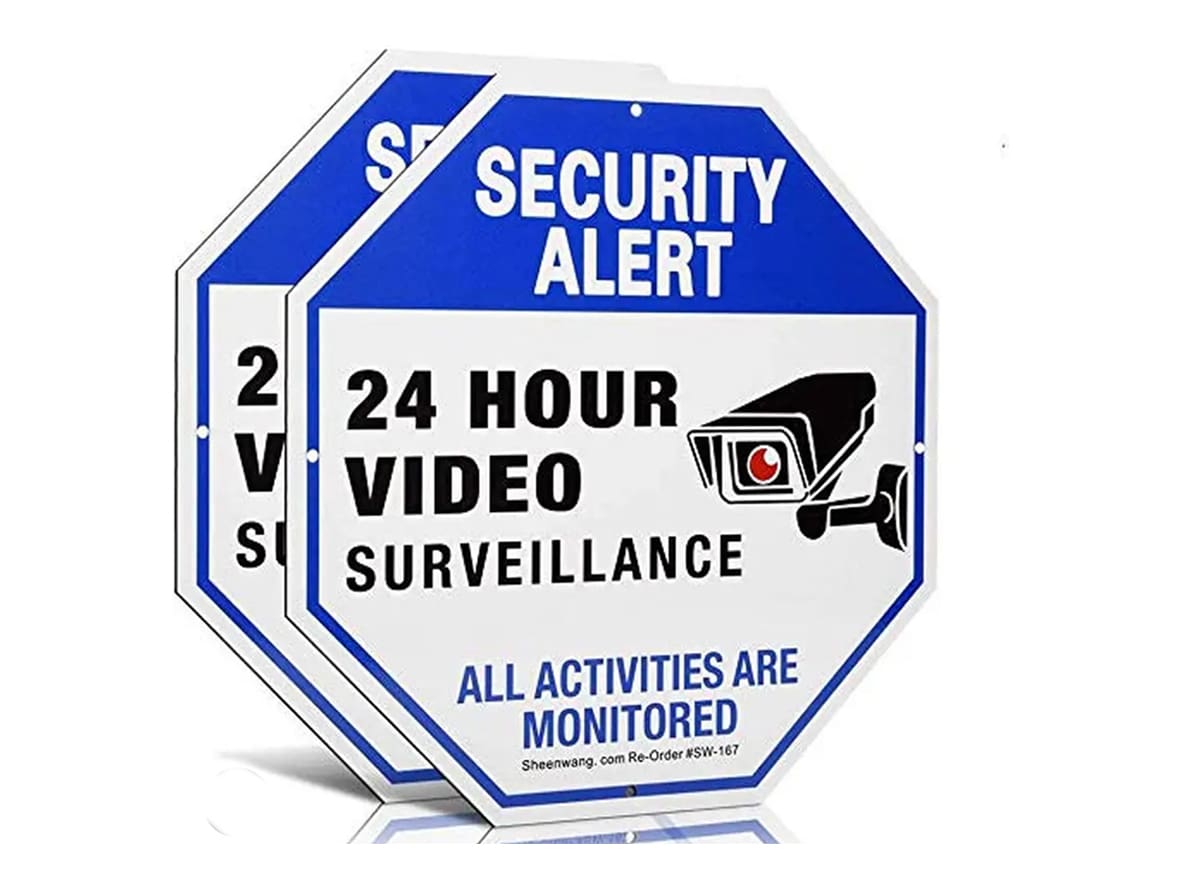 A pair of security alert signs with video surveillance.